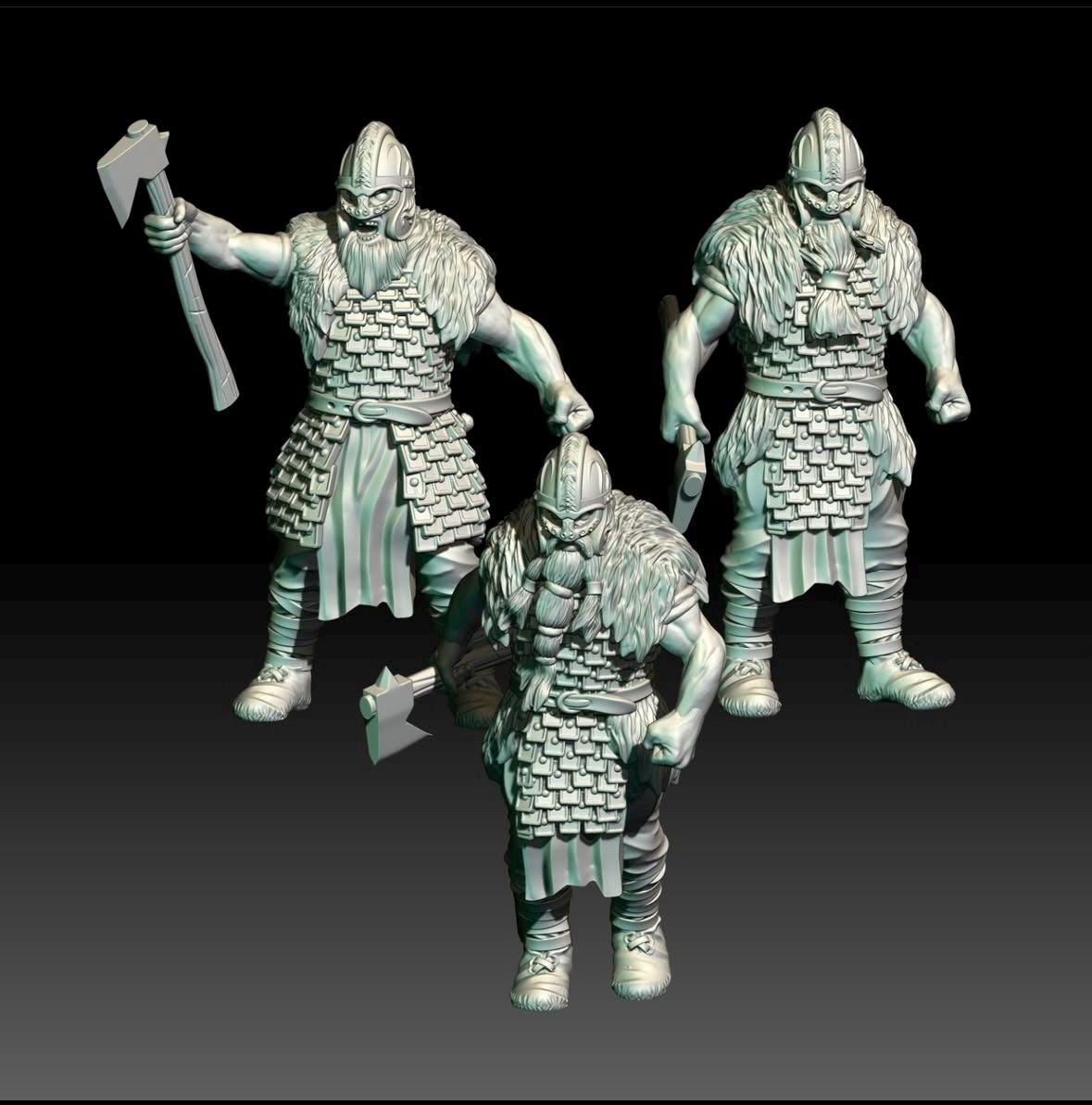 Three viking warrior figurines in armour with weapons on a black background