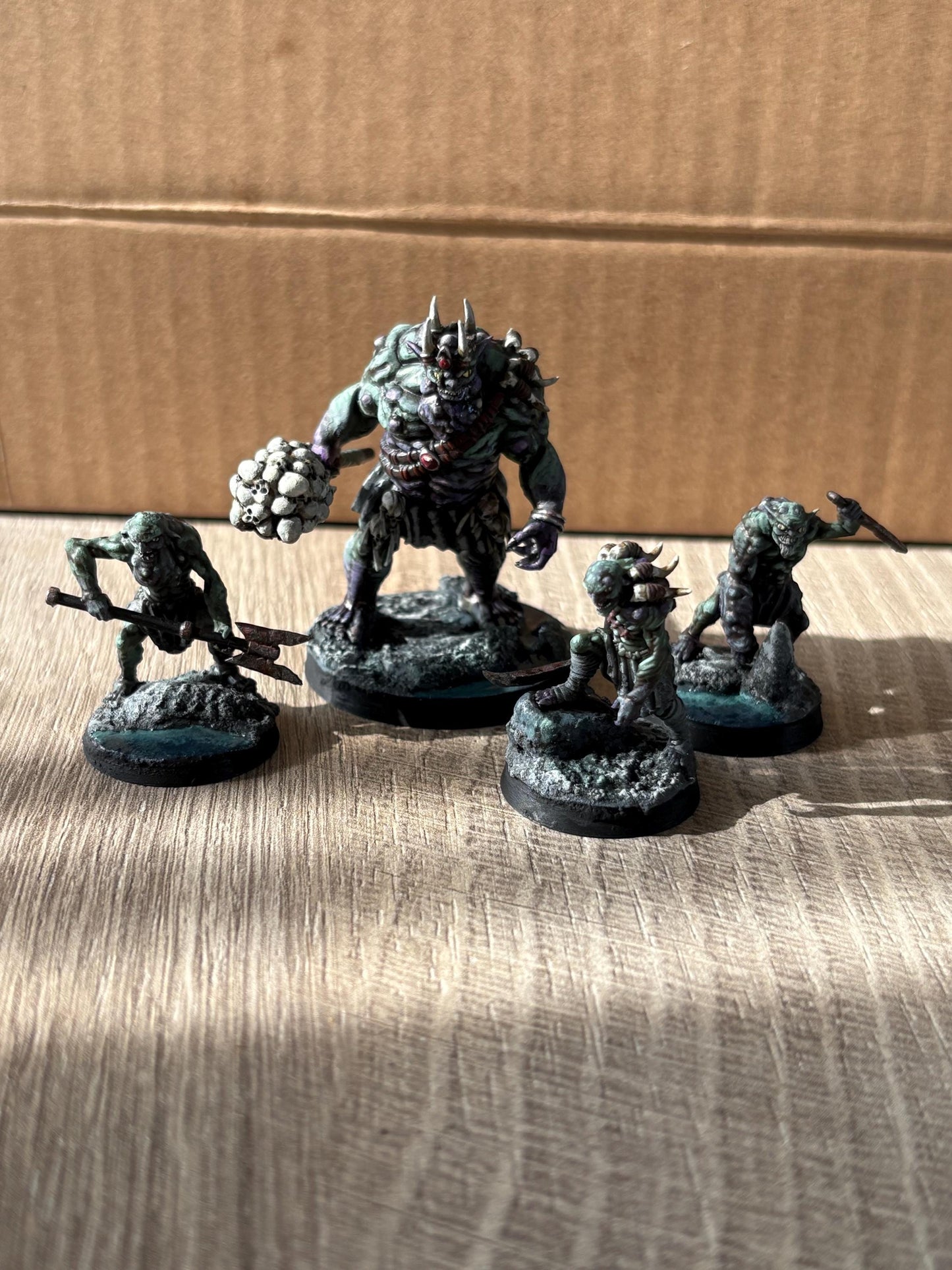 dark fantasy goblin king miniature with smaller goblin miniatures