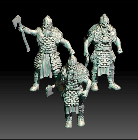 Three viking warrior figurines in armour with weapons on a black background