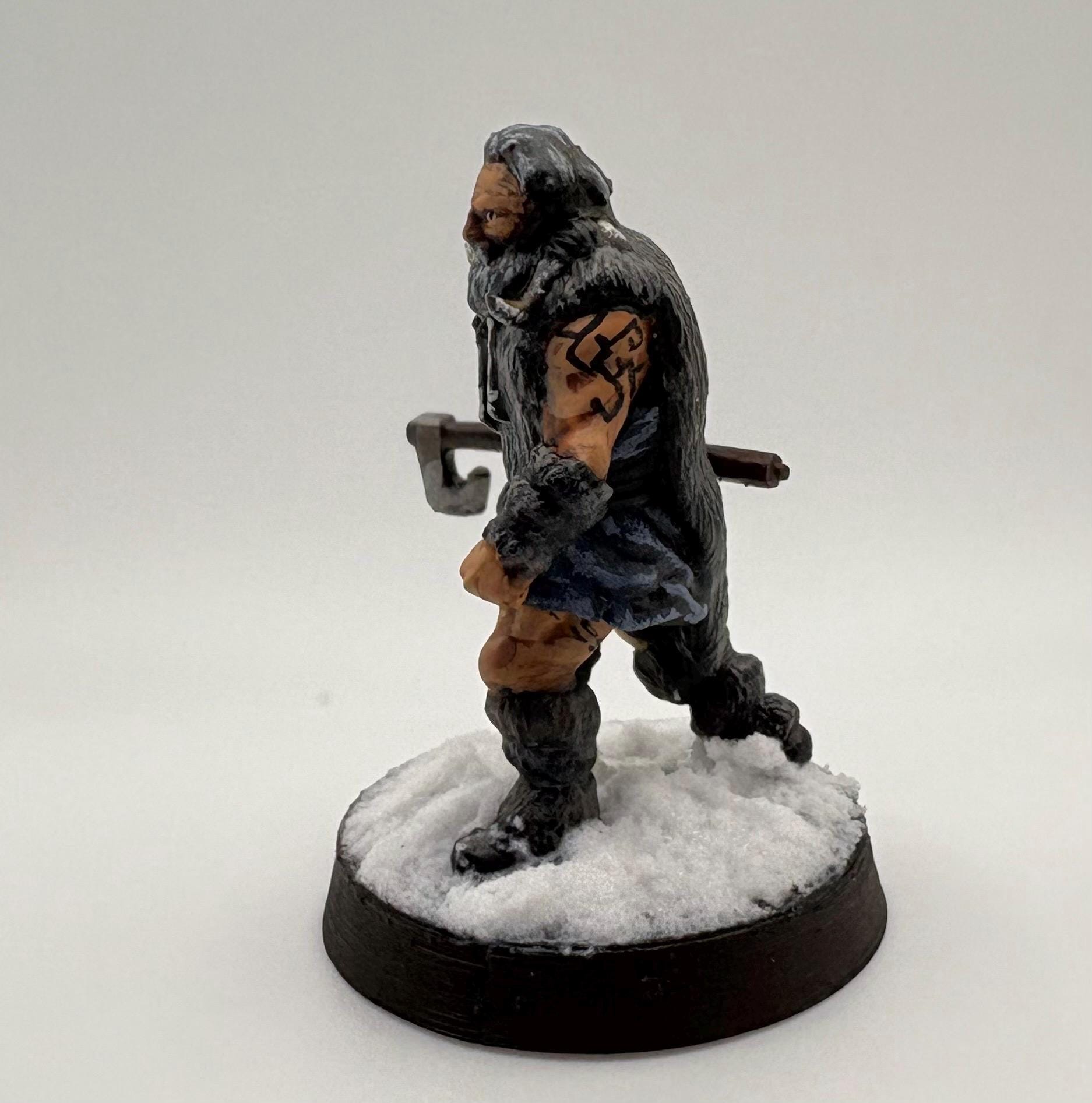 Miniature hillman figurine of a character with a tattoo on a white background